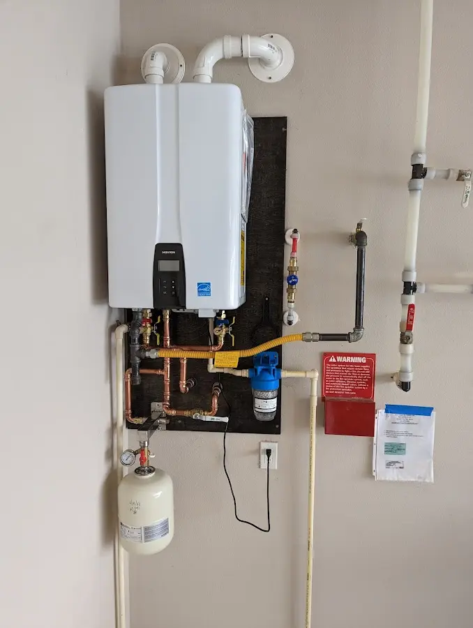 Professional plumber installing copper piping in a Lucerne home